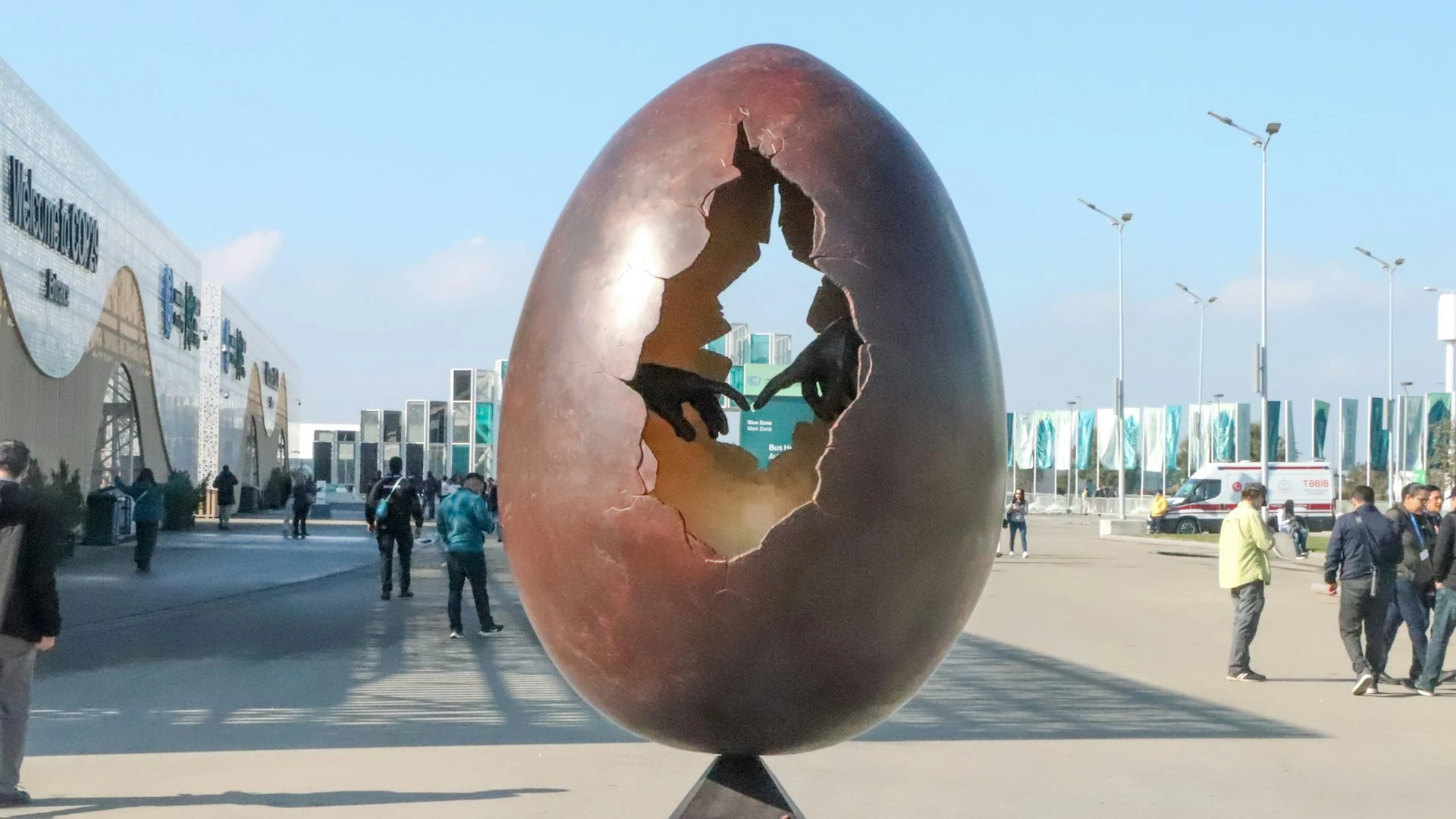 Das Foto zeigt die Skulptur eines aufgebrochenen Eis. Darin sind zwei Hände zu sehen, deren Fingerspitzen sich berühren.